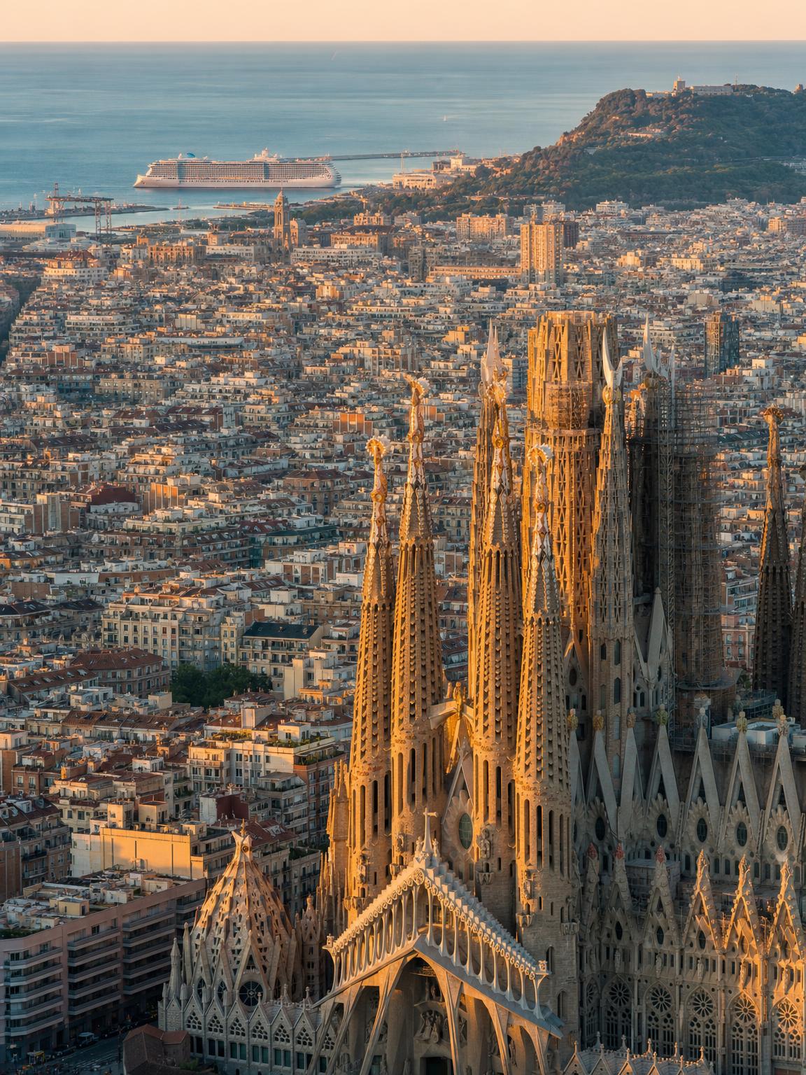 Aerial editorial photograph of Barcelona harbor, Sagrada Família skyline at golden hour — Virgin Voyages Scarlet Lady embarkation port, Mediterranean Solar Eclipse Cruise August 2026