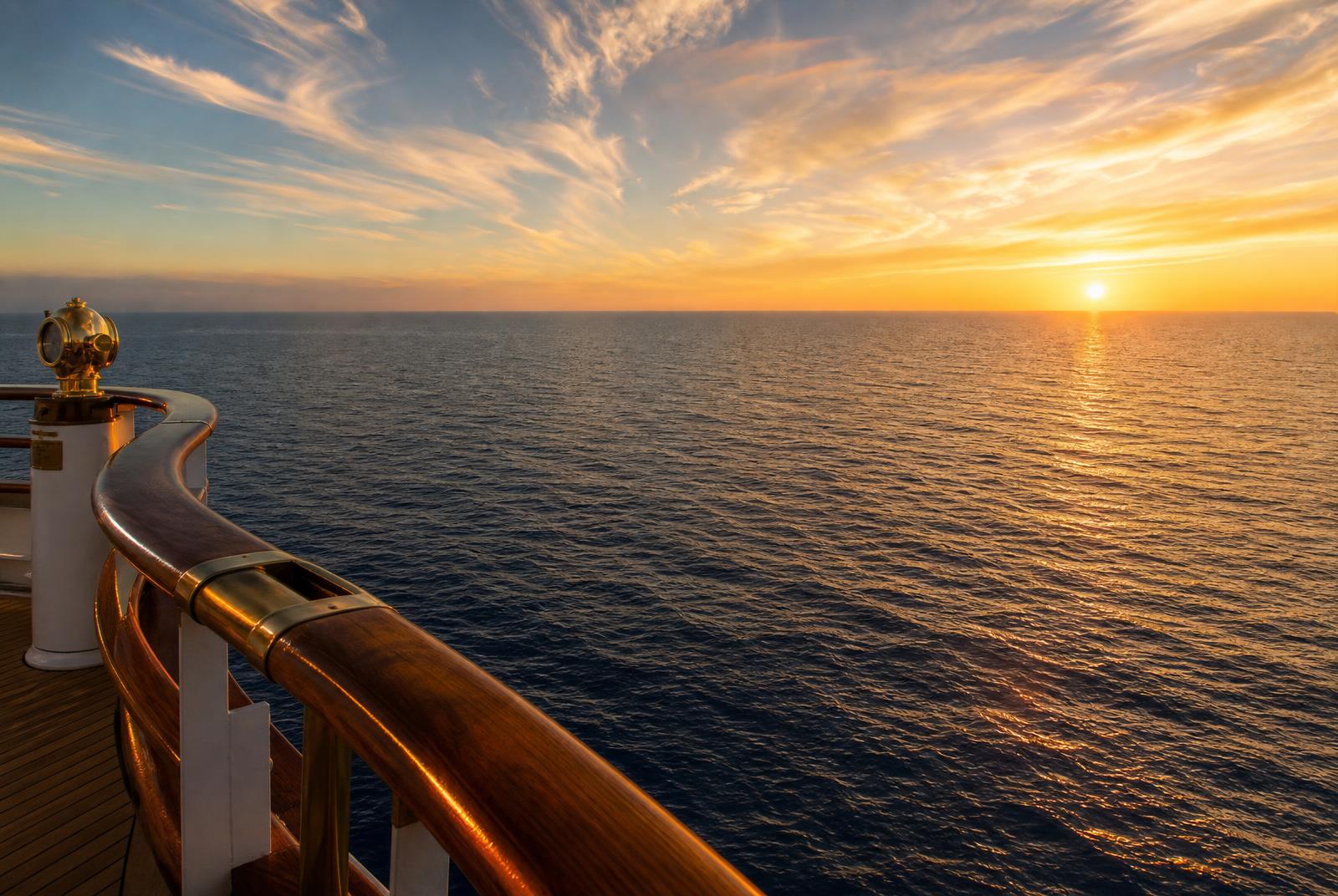 Deep blue open Mediterranean Sea at dusk from a luxury cruise deck — sea day aboard Virgin Voyages Scarlet Lady